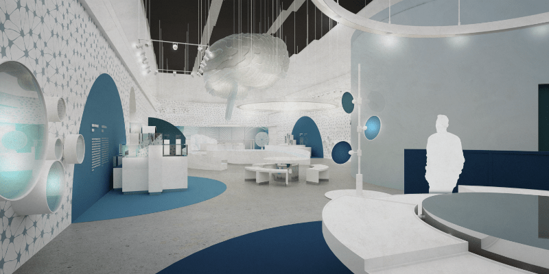Wizualizacja jednej z sal wystawy stałej. Widoczne białe meble oraz niebieskie dekoracje na ścianach. W głębi instalacje interaktywne, widoczny model mózgu.